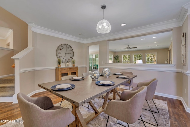 dining space with crown molding and wood-type flooring