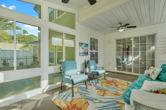 sunroom / solarium featuring ceiling fan