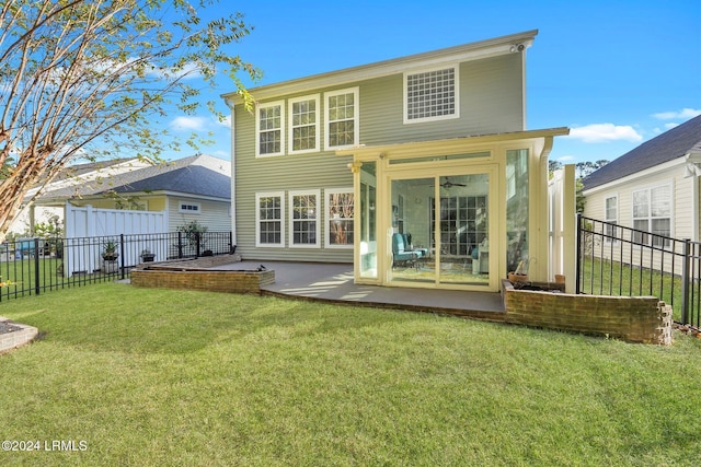 rear view of property with a lawn, a patio, and ceiling fan