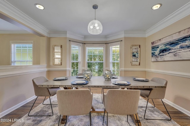 dining room with wood-type flooring and crown molding