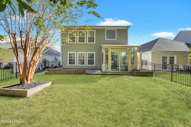 rear view of property featuring a lawn