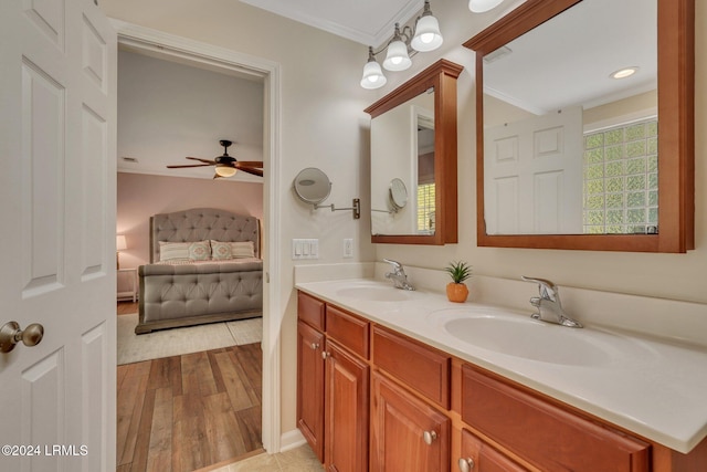 bathroom featuring crown molding, vanity, and hardwood / wood-style floors