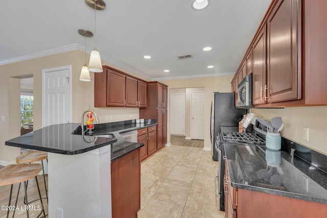 kitchen featuring a breakfast bar, decorative light fixtures, dark stone countertops, ornamental molding, and stainless steel appliances