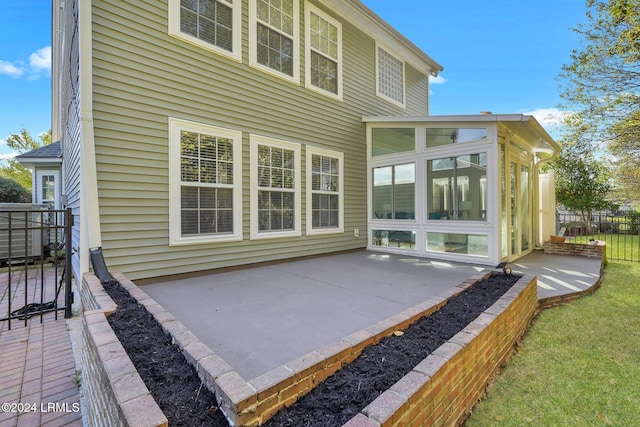 back of property featuring a patio area and a sunroom