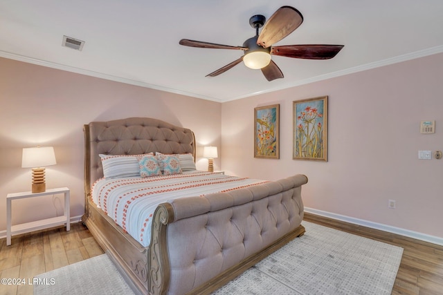 bedroom featuring hardwood / wood-style flooring, crown molding, and ceiling fan