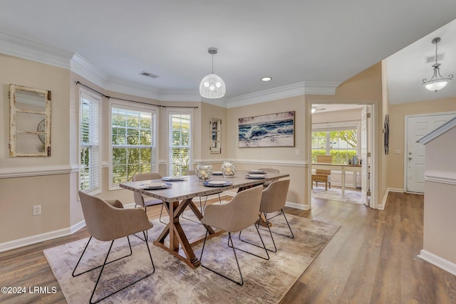 dining space featuring hardwood / wood-style flooring and ornamental molding