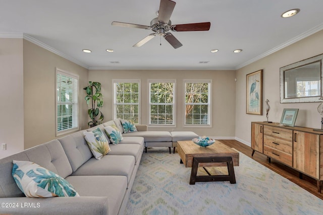 living room featuring crown molding, hardwood / wood-style flooring, and ceiling fan