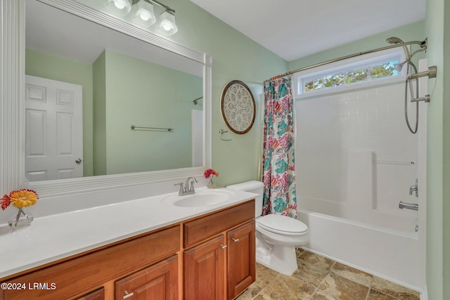 full bathroom featuring shower / bath combo, vanity, and toilet