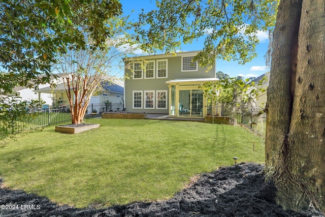 rear view of property with a yard