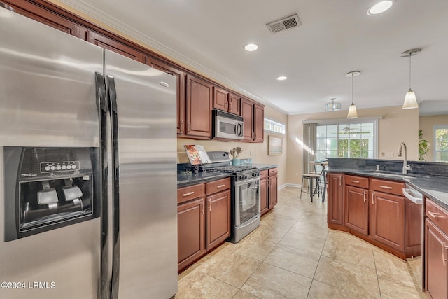 kitchen featuring pendant lighting, sink, crown molding, stainless steel appliances, and light tile patterned flooring