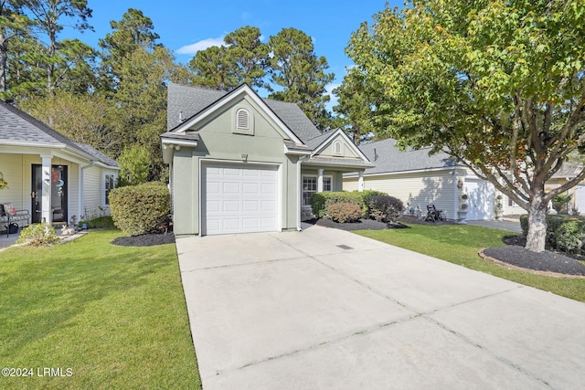 view of front of property with a garage and a front lawn