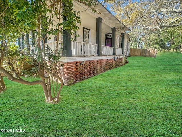 view of property exterior with a porch and a yard