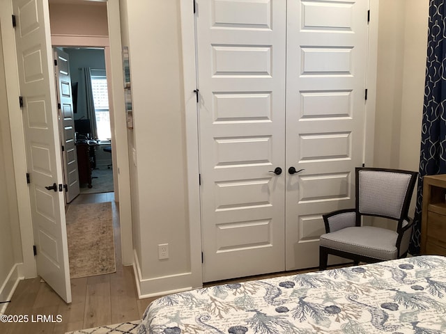 bedroom with a closet and light hardwood / wood-style flooring