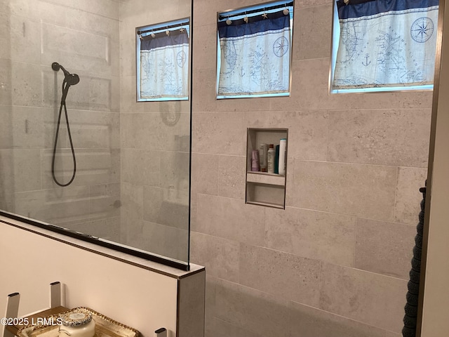 bathroom with tiled shower