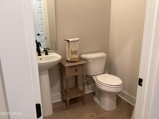 bathroom with sink, wood-type flooring, and toilet