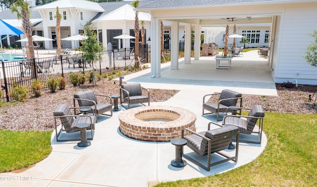 view of patio / terrace with ceiling fan and an outdoor fire pit