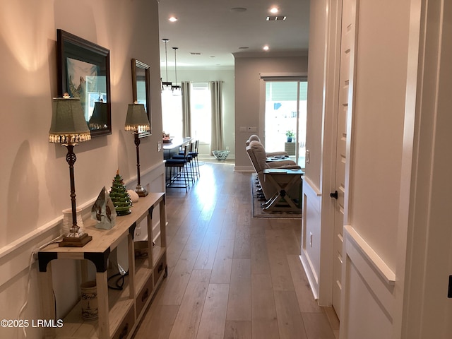 hall featuring crown molding and hardwood / wood-style floors