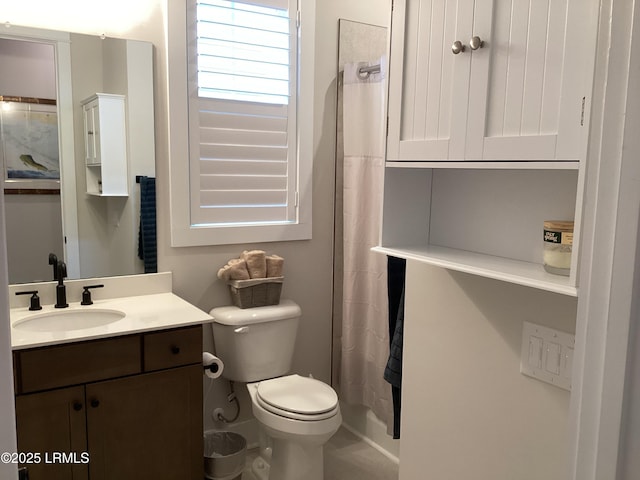 bathroom with vanity, curtained shower, and toilet