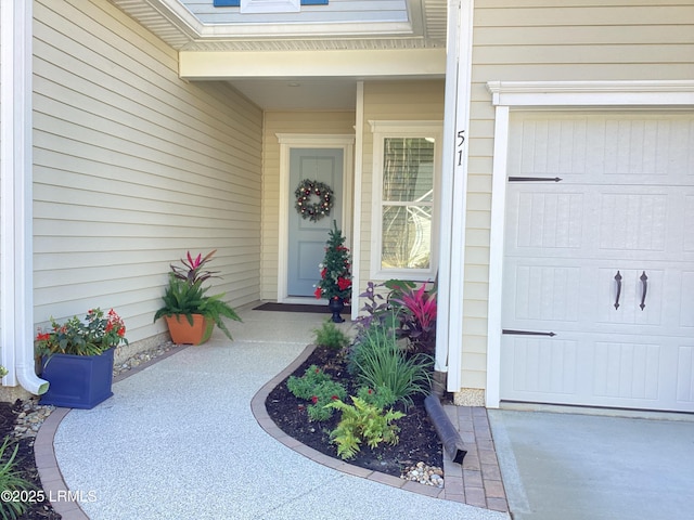 doorway to property with a garage