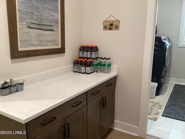 bathroom with vanity and washer / dryer