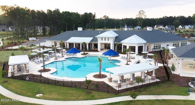 view of swimming pool featuring a pergola, a lawn, and a patio area