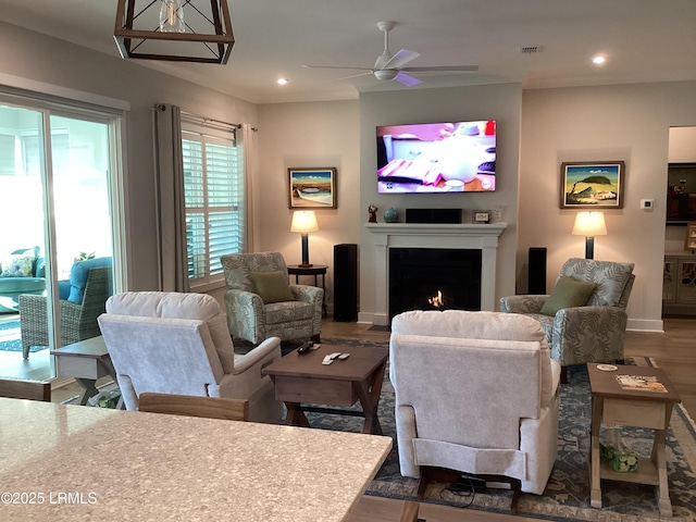 living room with dark wood-type flooring and ceiling fan