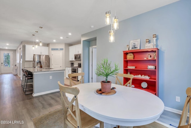 dining area with sink and hardwood / wood-style floors