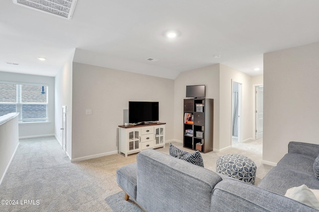 carpeted living room with vaulted ceiling