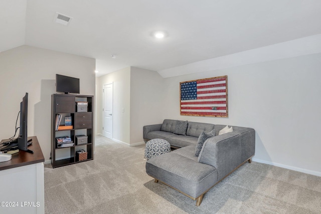 carpeted living room with vaulted ceiling