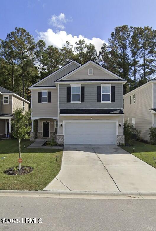 346 Sawmill Rd, Hardeeville, SC 29927 - traditional-style home featuring stone siding, a garage, concrete driveway, and a front yard