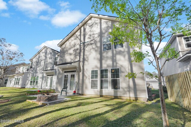 346 Sawmill Rd, Hardeeville, SC 29927 - rear view of house featuring a patio area, a fire pit, fence, and a lawn