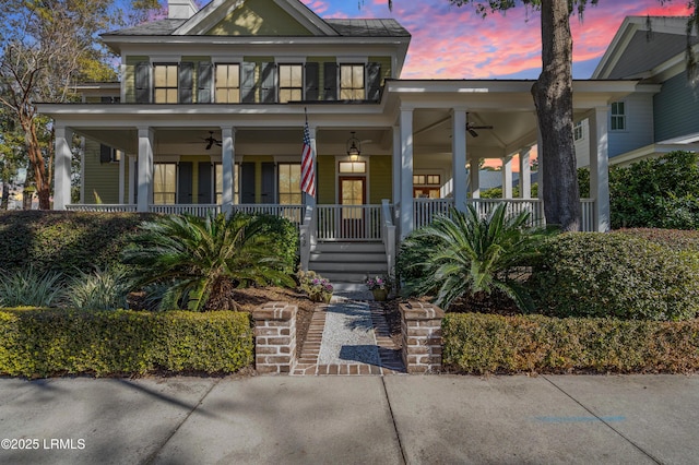 view of front of home featuring a porch, ceiling fan, and a chimney