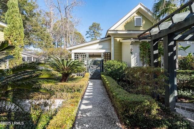 view of front of property featuring fence and a gate