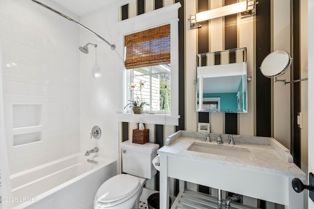 bathroom featuring shower / bathtub combination, a sink, and toilet