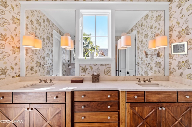 bathroom with double vanity, a sink, and wallpapered walls