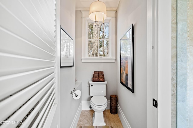 bathroom with toilet and baseboards