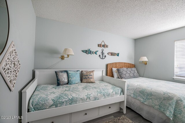 bedroom featuring hardwood / wood-style floors and a textured ceiling