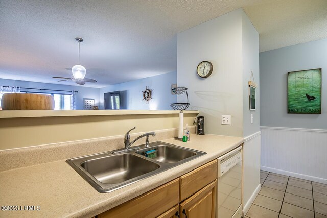 kitchen featuring ceiling fan, white dishwasher, sink, and light tile patterned floors