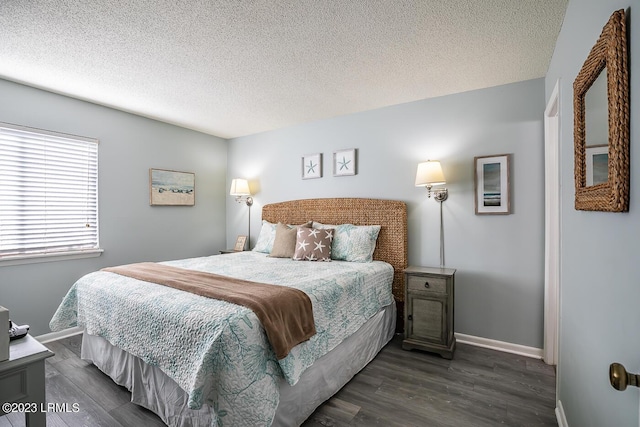 bedroom with dark hardwood / wood-style flooring and a textured ceiling