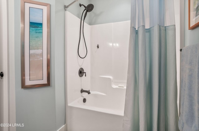 bathroom featuring shower / tub combo with curtain