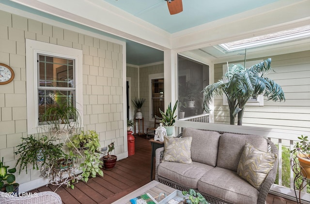 sunroom / solarium featuring ceiling fan