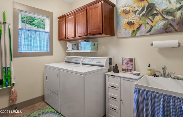 laundry area featuring cabinets, washer and dryer, sink, and light tile patterned floors