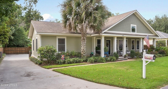 view of front of house featuring a front yard and covered porch