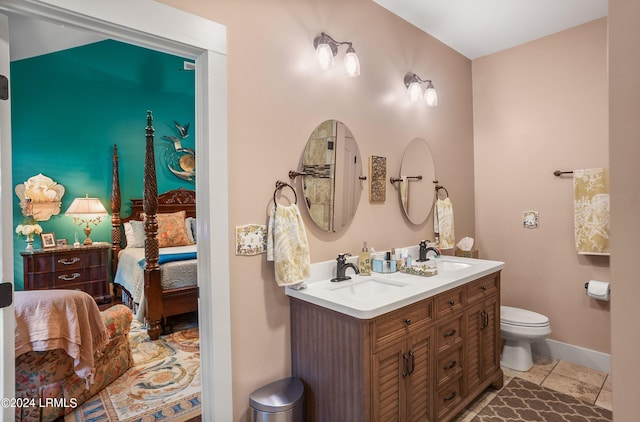 bathroom featuring vanity, tile patterned floors, and toilet