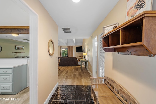 corridor featuring vaulted ceiling with beams and hardwood / wood-style flooring