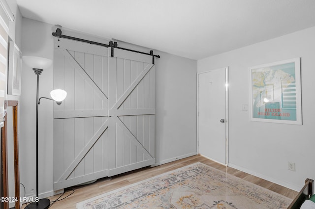 interior space with a barn door and light wood-type flooring