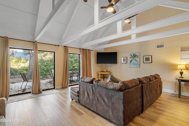 living room featuring high vaulted ceiling, light hardwood / wood-style floors, beamed ceiling, and ceiling fan