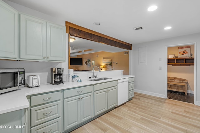 kitchen with dishwasher, sink, and light wood-type flooring