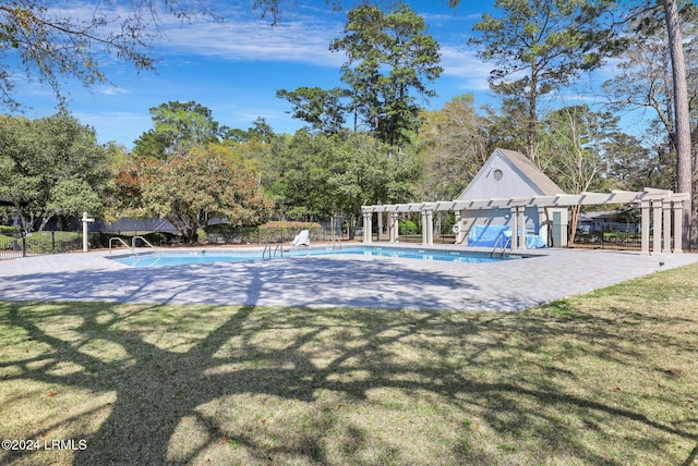 view of pool with a yard and a pergola