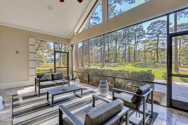 sunroom featuring a wealth of natural light, ceiling fan, and vaulted ceiling